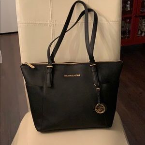 Genuine Michael Kors black purse. Zip closure